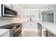 Modern kitchen featuring white cabinets, stainless steel appliances, and marble countertops at 1400 Gulf Blvd # 801, Clearwater Beach, FL 33767