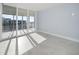 Bright room with balcony access offering stunning ocean and city views through large windows at 1400 Gulf Blvd # 801, Clearwater Beach, FL 33767