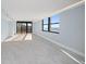 Open living space with large windows, balcony access, and marble flooring at 1400 Gulf Blvd # 801, Clearwater Beach, FL 33767