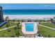Stunning oceanfront pool with tiki huts and lush landscaping, offering the ultimate resort-style living experience at 1400 Gulf Blvd # 801, Clearwater Beach, FL 33767