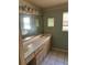 Bathroom with double sink vanity and large mirror at 14303 14Th St, Dade City, FL 33523