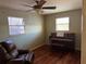 Bright bedroom with hardwood floors, large windows, and a comfortable recliner at 14303 14Th St, Dade City, FL 33523