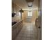 Kitchen with wood cabinets and tiled floor at 14303 14Th St, Dade City, FL 33523