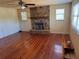 Spacious living room featuring hardwood floors and a stone fireplace at 14303 14Th St, Dade City, FL 33523