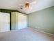 Spacious bedroom with ceiling fan, carpet, and large closet at 16861 Le Clare Shores Dr, Tampa, FL 33624