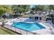 Inviting community pool with surrounding patio furniture at 16861 Le Clare Shores Dr, Tampa, FL 33624