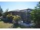 Backyard with lush landscaping and a screened lanai at 1727 Coco Palm Cir, Sun City Center, FL 33573