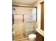 Tiled bathroom shower with glass doors and decorative tile accent at 1727 Coco Palm Cir, Sun City Center, FL 33573