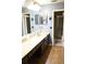 Bathroom featuring a double sink vanity with granite countertops, and a shower with glass doors at 1727 Coco Palm Cir, Sun City Center, FL 33573