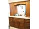 Bathroom vanity with granite countertop, custom wood cabinets, and a decorative mirror at 1727 Coco Palm Cir, Sun City Center, FL 33573