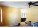 Bright bedroom with ceiling fan and access to bathroom at 1727 Coco Palm Cir, Sun City Center, FL 33573