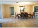 Spacious dining room with tile floors and decorative chandelier at 1727 Coco Palm Cir, Sun City Center, FL 33573