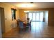 Dining room with tiled flooring, traditional chandelier, and view into living room with french doors at 1727 Coco Palm Cir, Sun City Center, FL 33573