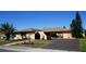 Single-story home with a large driveway and landscaped yard at 1727 Coco Palm Cir, Sun City Center, FL 33573