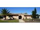Front view of a single-story house with a palm tree and well-kept lawn at 1727 Coco Palm Cir, Sun City Center, FL 33573