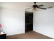 Spacious main bedroom with ceiling fan, carpeted floors, and view into ensuite bathroom at 1727 Coco Palm Cir, Sun City Center, FL 33573