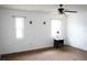Bright main bedroom featuring a ceiling fan and two windows at 1727 Coco Palm Cir, Sun City Center, FL 33573