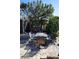Comfortable outdoor patio with a large shade tree, providing a relaxing space for outdoor dining and leisure at 1727 Coco Palm Cir, Sun City Center, FL 33573