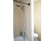 Bathroom shower with updated showerhead and neutral tile at 1727 Coco Palm Cir, Sun City Center, FL 33573