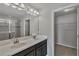 Double vanity bathroom with a large mirror and walk-in shower at 18843 Ulmus St, Lutz, FL 33558