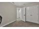 Bright bedroom with double doors leading to a hallway at 18843 Ulmus St, Lutz, FL 33558