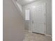 Light and airy entryway with tiled floor, staircase and a view to the living room at 18843 Ulmus St, Lutz, FL 33558
