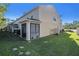 Tan house exterior with private patio at 18843 Ulmus St, Lutz, FL 33558