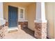 Inviting entryway with a dark blue front door, stone accents and a brick walkway at 18843 Ulmus St, Lutz, FL 33558