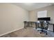 Small home office with corner desk and two monitors at 18843 Ulmus St, Lutz, FL 33558