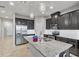 Modern kitchen with dark cabinetry, granite countertops and stainless steel appliances at 18843 Ulmus St, Lutz, FL 33558