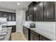 Modern kitchen with dark cabinetry, granite countertops and stainless steel appliances at 18843 Ulmus St, Lutz, FL 33558