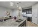 Kitchen island with granite countertop, double sink, and a breakfast bar at 18843 Ulmus St, Lutz, FL 33558