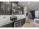 Kitchen with dark cabinets, granite counters, and stainless steel appliances at 18843 Ulmus St, Lutz, FL 33558