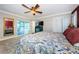 Main bedroom with king-size bed, access to patio, and built-in closet at 2261 Hidden Meadows E Dr, Palm Harbor, FL 34683