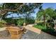 Peaceful patio with wicker chairs and fire pit at 2261 Hidden Meadows E Dr, Palm Harbor, FL 34683