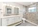 Updated bathroom with double vanity, large shower, and tile flooring at 2746 Hibiscus St, Sarasota, FL 34239