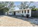 Updated home exterior featuring a paver driveway and modern facade at 2746 Hibiscus St, Sarasota, FL 34239