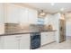 White kitchen cabinets, stainless steel appliances, and decorative backsplash at 2746 Hibiscus St, Sarasota, FL 34239