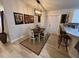 Bright dining room features a wooden table, white chairs, and an open feel at 3087 Seth Rd, North Port, FL 34288