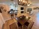 Dining area with a wooden table, white chairs, and a modern light fixture at 3087 Seth Rd, North Port, FL 34288
