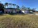One-story home with a gray exterior, a two-car garage, and a well-manicured lawn at 3087 Seth Rd, North Port, FL 34288
