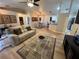 Open concept living room with light-colored flooring, a comfortable sofa, and a large TV at 3087 Seth Rd, North Port, FL 34288