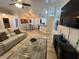 Spacious living room with light floors, a white couch, and an open floor plan at 3087 Seth Rd, North Port, FL 34288