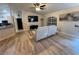 Living area featuring light wood flooring, a white couch, and a large flat-screen TV at 3087 Seth Rd, North Port, FL 34288