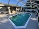 Refreshing pool with a unique shape and screened enclosure at 3087 Seth Rd, North Port, FL 34288