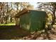 Green metal outbuilding in wooded area at 39716 Tworut Rd, Webster, FL 33597