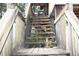 Exterior wooden staircase leading to the elevated home's deck at 39716 Tworut Rd, Webster, FL 33597