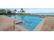 Sparkling lap pool overlooking scenic bay with lounge seating at 4951 Bacopa S Ln # 302, St Petersburg, FL 33715