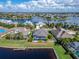 Aerial view of a home with a pool and dock, in a tranquil waterfront setting at 5316 Loon Nest Ct, Apollo Beach, FL 33572