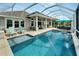 Inviting swimming pool with covered patio and lounge seating at 5316 Loon Nest Ct, Apollo Beach, FL 33572